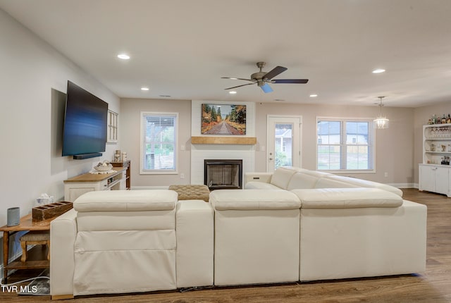 living room featuring wood-type flooring and ceiling fan