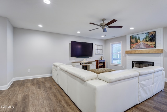 living room with a fireplace, hardwood / wood-style floors, and ceiling fan