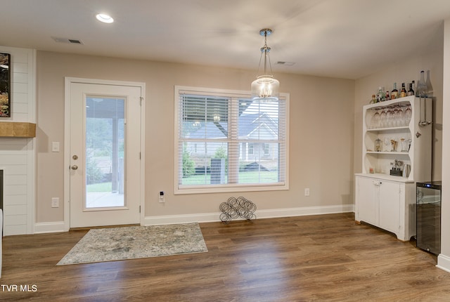 unfurnished dining area with a fireplace and dark hardwood / wood-style floors