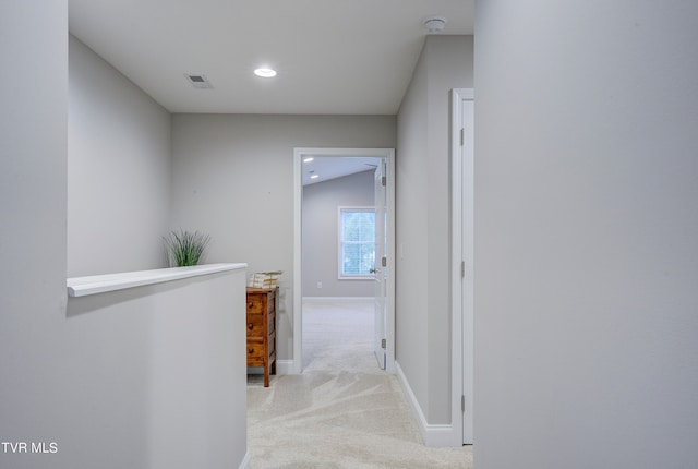 corridor featuring light carpet and lofted ceiling