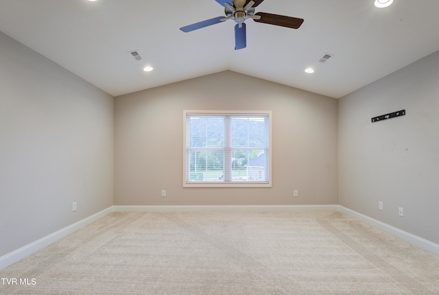 carpeted spare room featuring ceiling fan and lofted ceiling