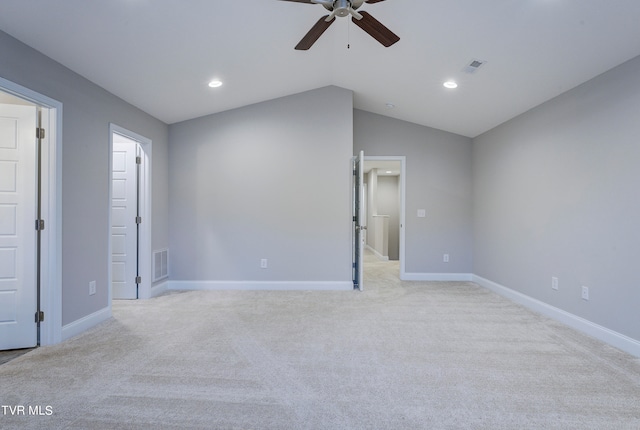 unfurnished bedroom with ceiling fan, light colored carpet, and vaulted ceiling