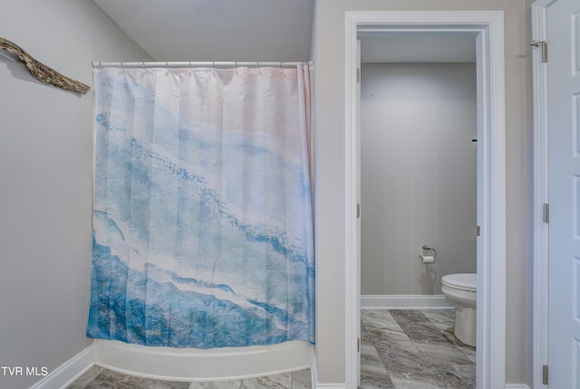 bathroom with a shower with curtain and toilet