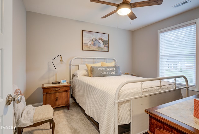 bedroom with ceiling fan and light colored carpet