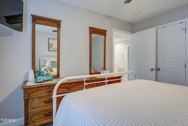 bedroom with ceiling fan and a closet