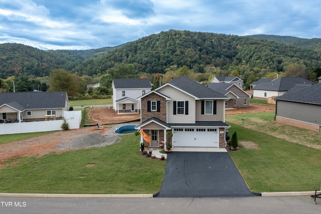 view of front of property with a garage and a front yard