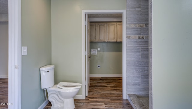 bathroom with toilet and wood-type flooring