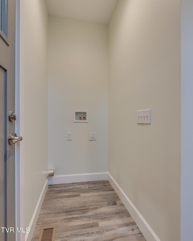 laundry area featuring washer hookup, hookup for an electric dryer, and light wood-type flooring