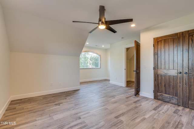 bonus room with ceiling fan, light wood-type flooring, and vaulted ceiling