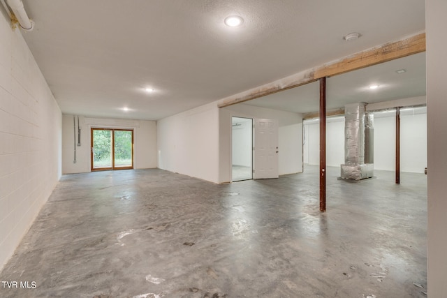 interior space featuring a textured ceiling and concrete floors