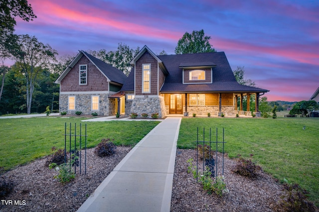 view of front of home with a porch and a yard