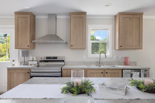 kitchen featuring ornamental molding, sink, wall chimney exhaust hood, appliances with stainless steel finishes, and light brown cabinets