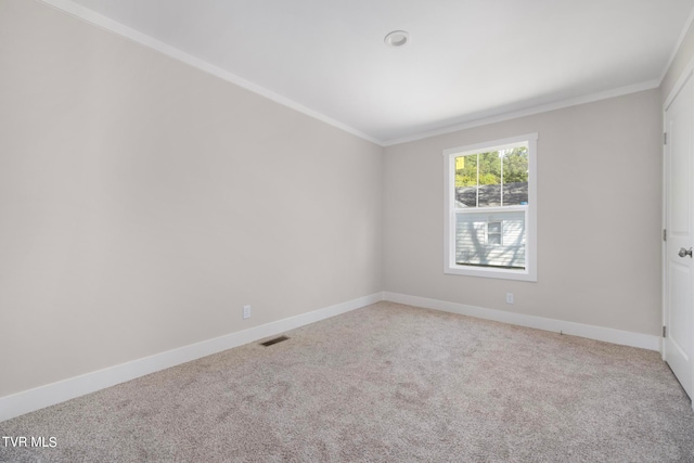 carpeted spare room with crown molding