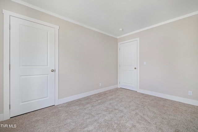 spare room featuring ornamental molding and light carpet