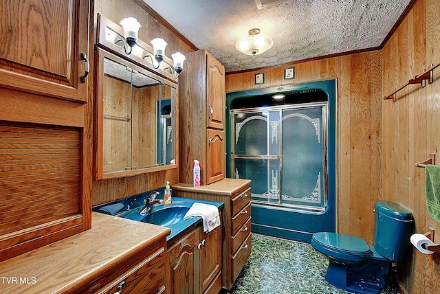 bathroom featuring wood walls, a textured ceiling, toilet, vanity, and ornamental molding