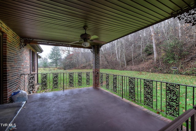 view of patio featuring ceiling fan and a balcony