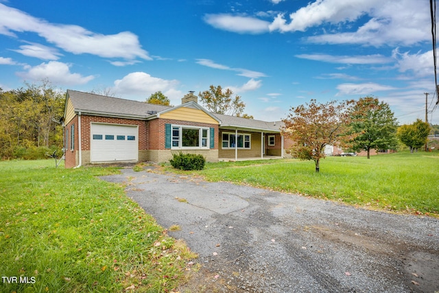 ranch-style house featuring a garage and a front lawn