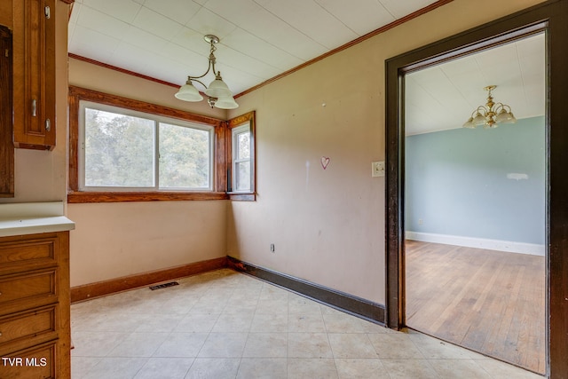 interior space featuring ornamental molding, light hardwood / wood-style floors, and a chandelier