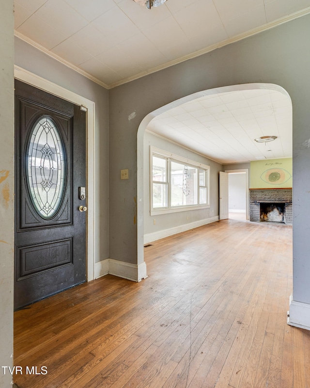 entrance foyer with wood-type flooring and ornamental molding