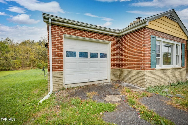 view of side of home with a garage and a yard