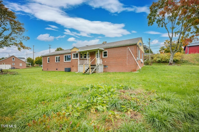 back of property with a lawn