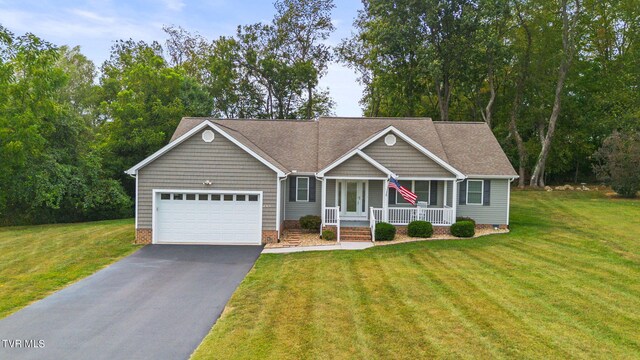 view of front of house featuring a garage, a front lawn, and a porch