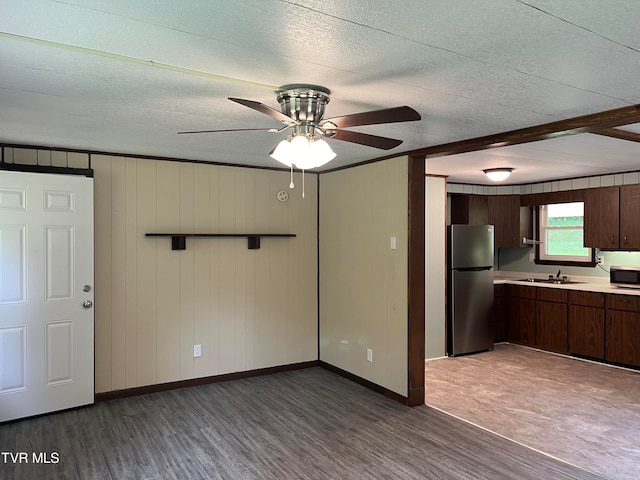 kitchen featuring appliances with stainless steel finishes, dark hardwood / wood-style flooring, dark brown cabinets, and ceiling fan