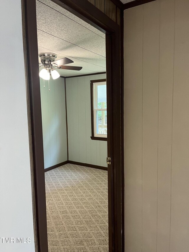 carpeted empty room featuring ceiling fan