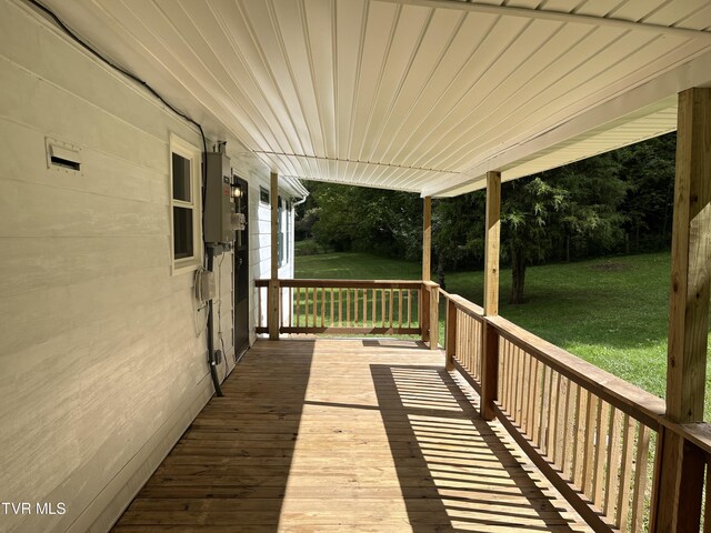 wooden deck with a lawn