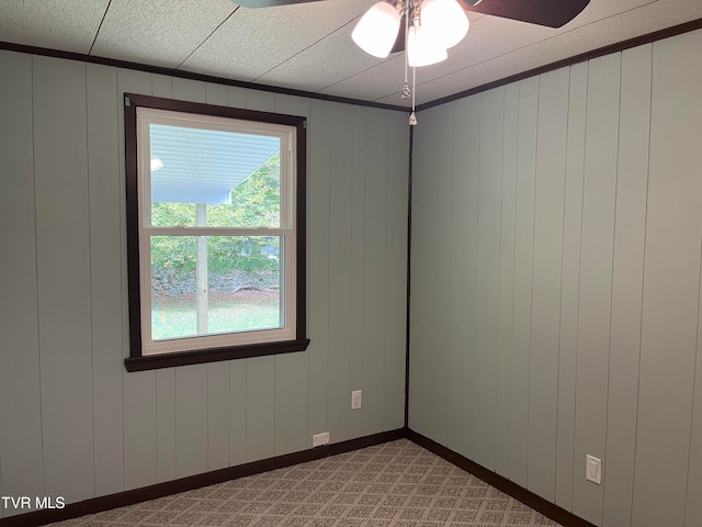 spare room featuring light colored carpet and ceiling fan