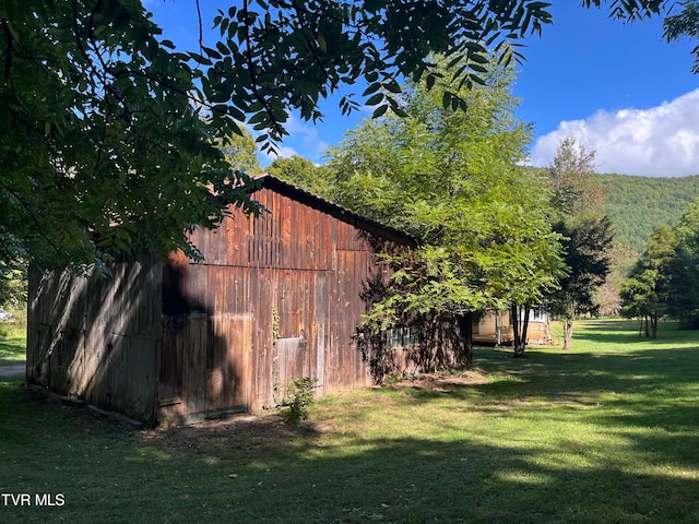 view of outdoor structure featuring a lawn