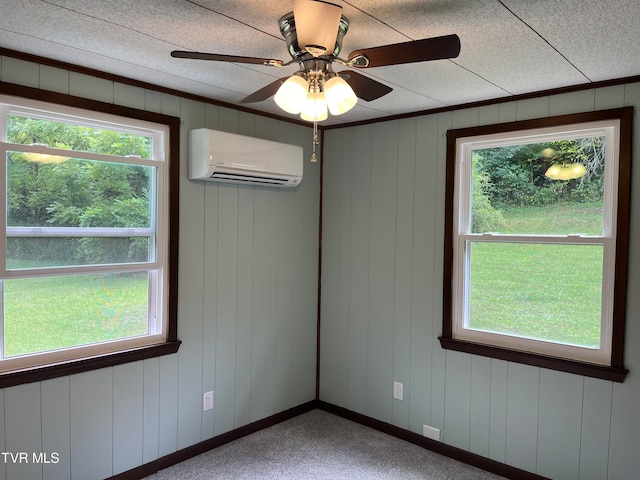 carpeted empty room with a wall mounted AC and ceiling fan