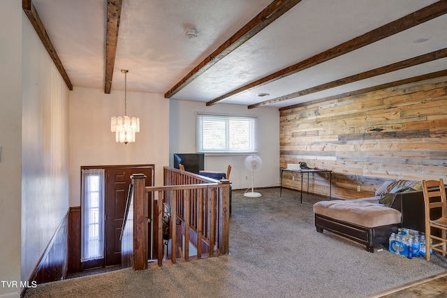 entryway with dark carpet, beamed ceiling, wood walls, and a notable chandelier