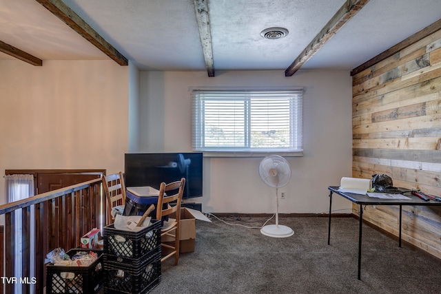 misc room featuring carpet flooring, a textured ceiling, and beam ceiling