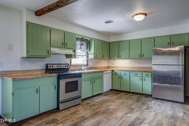 kitchen featuring light hardwood / wood-style flooring, green cabinetry, beamed ceiling, and appliances with stainless steel finishes