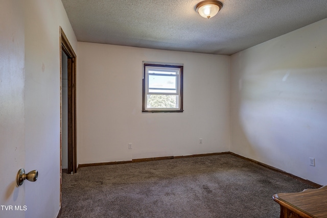 unfurnished room featuring a textured ceiling and carpet floors