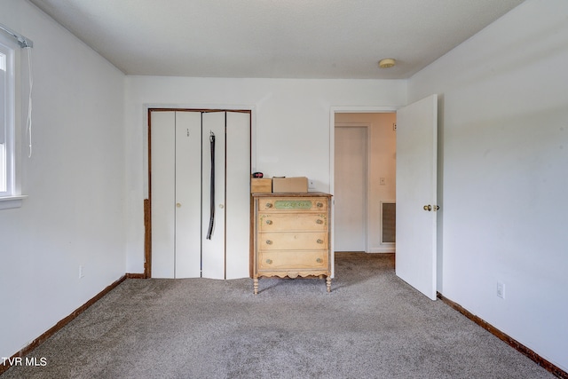 unfurnished bedroom featuring a closet and carpet floors