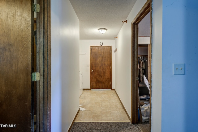 hallway featuring a textured ceiling