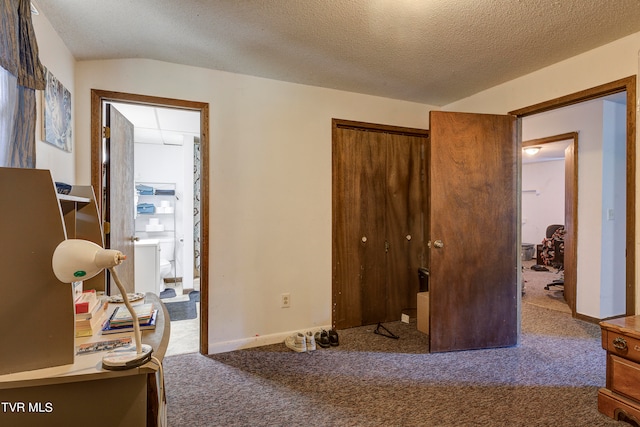 carpeted bedroom featuring a textured ceiling, a closet, and vaulted ceiling