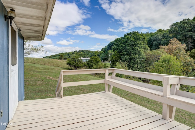 wooden terrace with a lawn