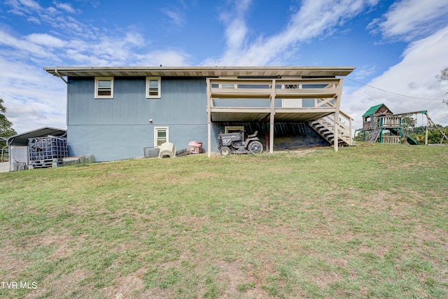 back of house with a playground and a yard