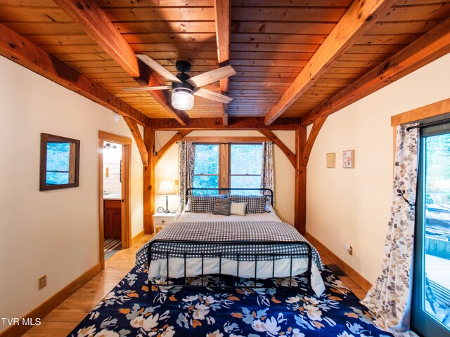 bedroom featuring light hardwood / wood-style floors, connected bathroom, beamed ceiling, wooden ceiling, and ceiling fan