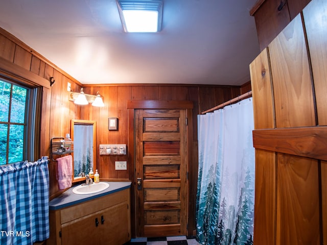 bathroom featuring vanity and wooden walls