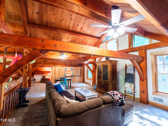 carpeted living room with ceiling fan, vaulted ceiling with beams, wooden walls, and wooden ceiling