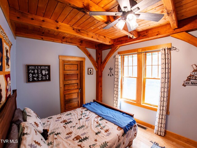 bedroom with light hardwood / wood-style floors, ceiling fan, beamed ceiling, and wooden ceiling