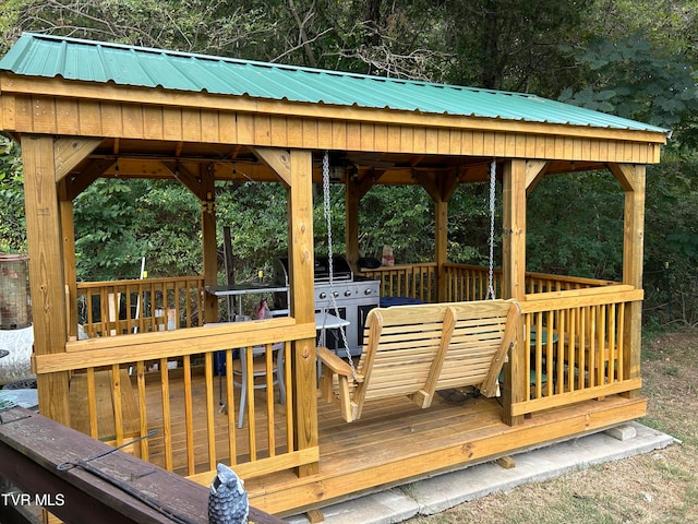 wooden deck featuring grilling area and a gazebo