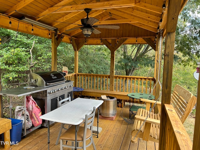 wooden terrace featuring a gazebo, grilling area, and ceiling fan