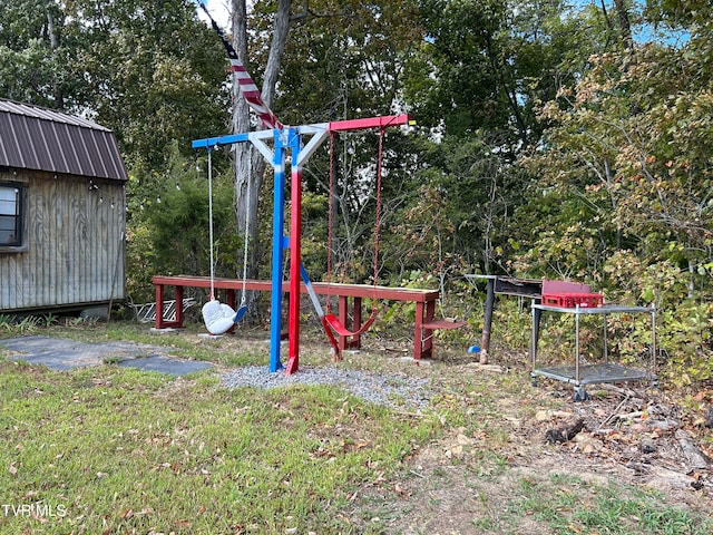 view of jungle gym featuring a shed and a yard