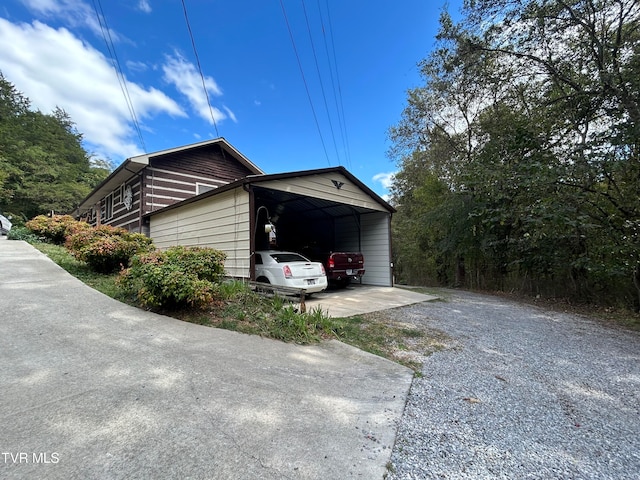 view of side of home with a carport