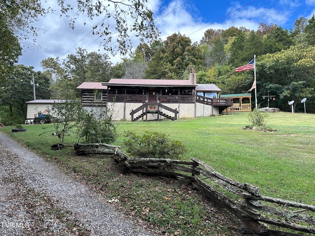 view of yard with a deck and an outbuilding